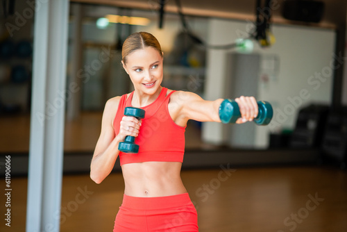 Woman boxing with dumbbells in a gym