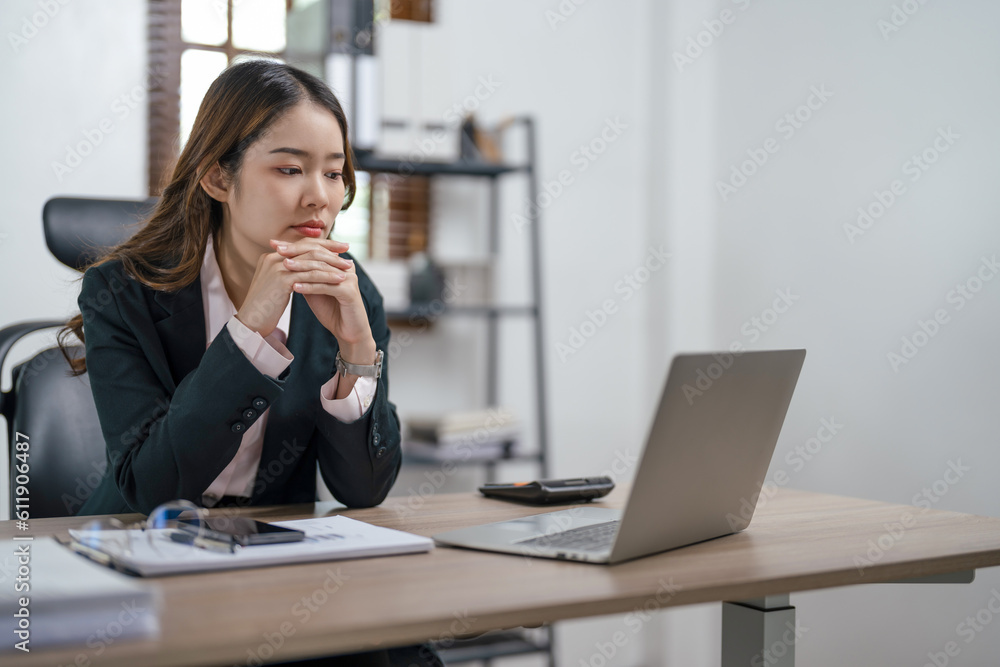 Young asian woman secretary working with laptop at contemporary office.. Young asian woman secretary working with laptop at contemporary office..
