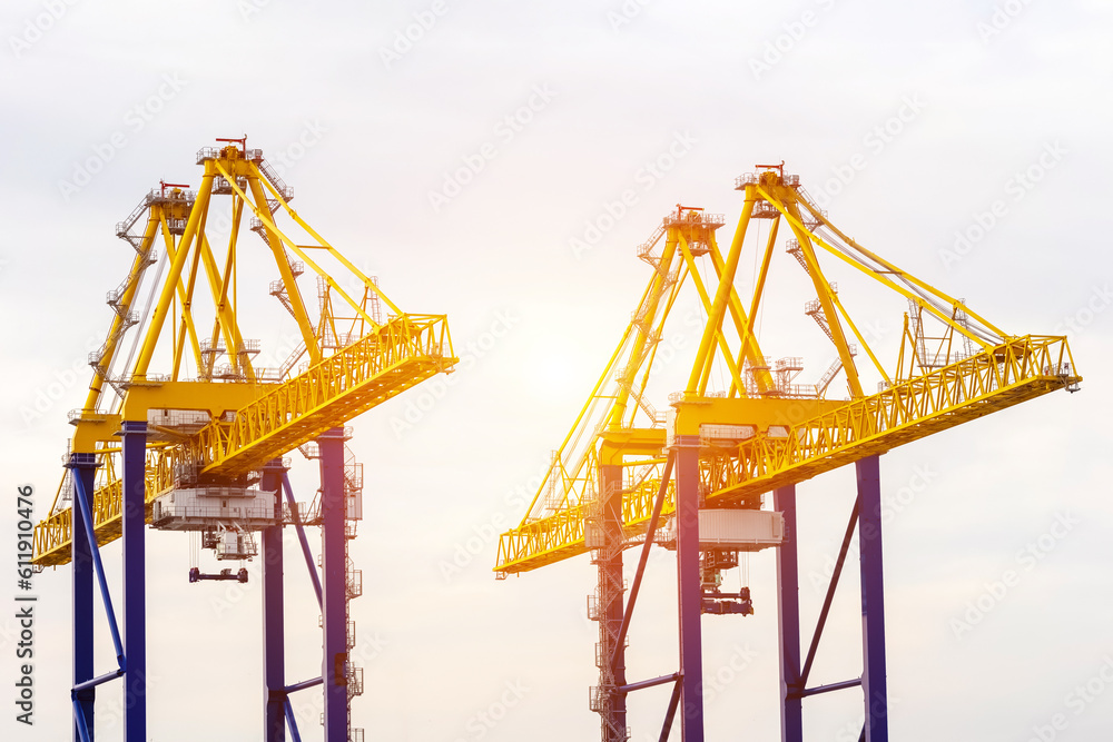 Port cranes on sky background