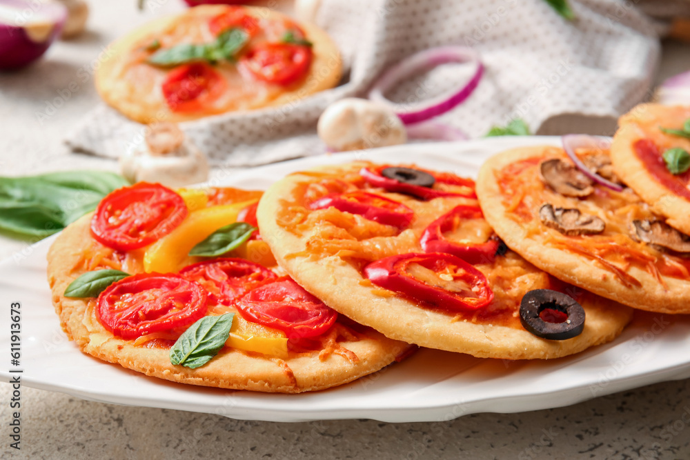 Plate with different tasty mini pizzas, closeup Plate with different tasty mini pizzas, closeup