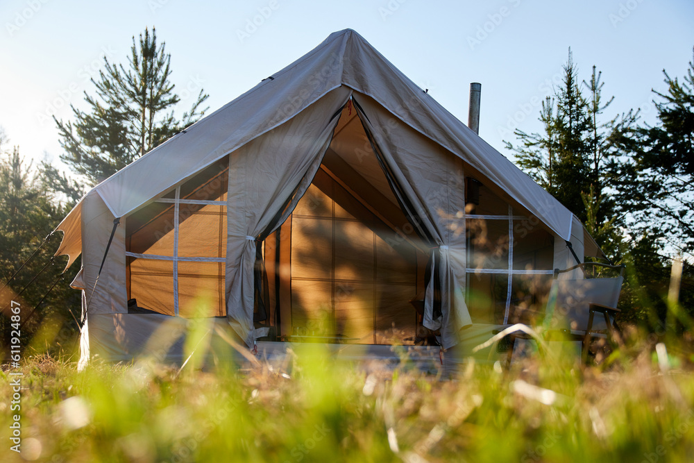 Camping tent under the pine forest. Inflatable tent Camping tent under the pine forest. Inflatable tent