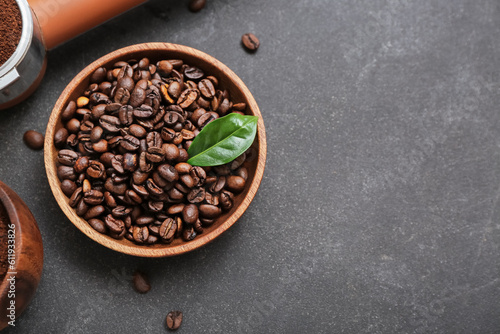 Bowl with coffee beans on dark background