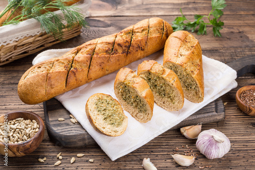garlic baguette roll on a wooden cutting board