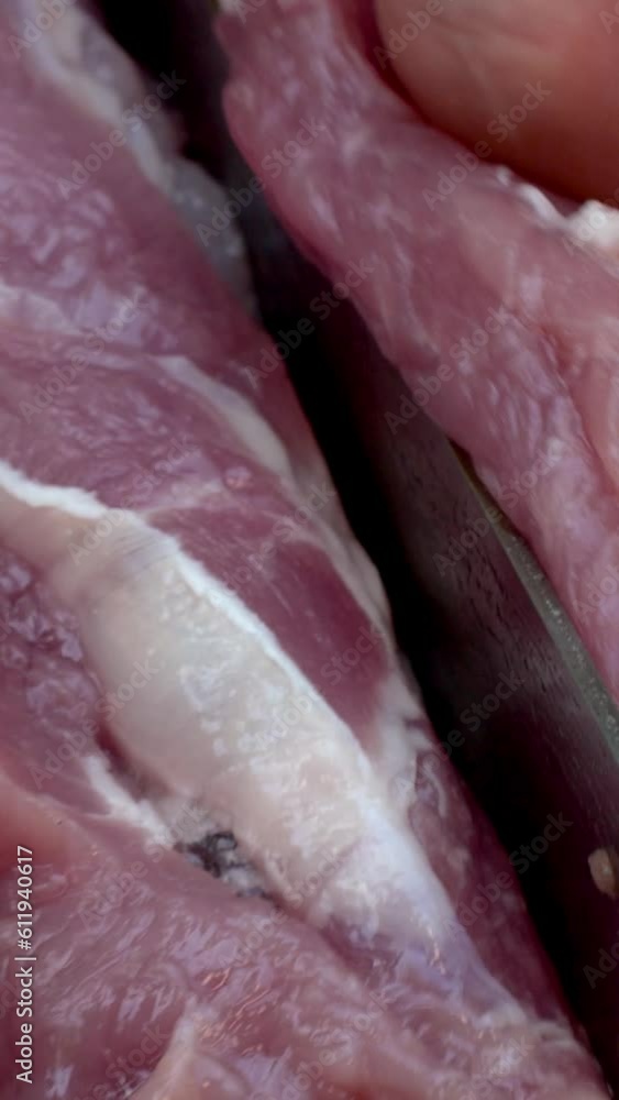 Expertly slicing juicy pork into big, mouth-watering chunks, to grilling on BBQ. Expertly slicing juicy pork into big, mouth-watering chunks, to grilling on BBQ.