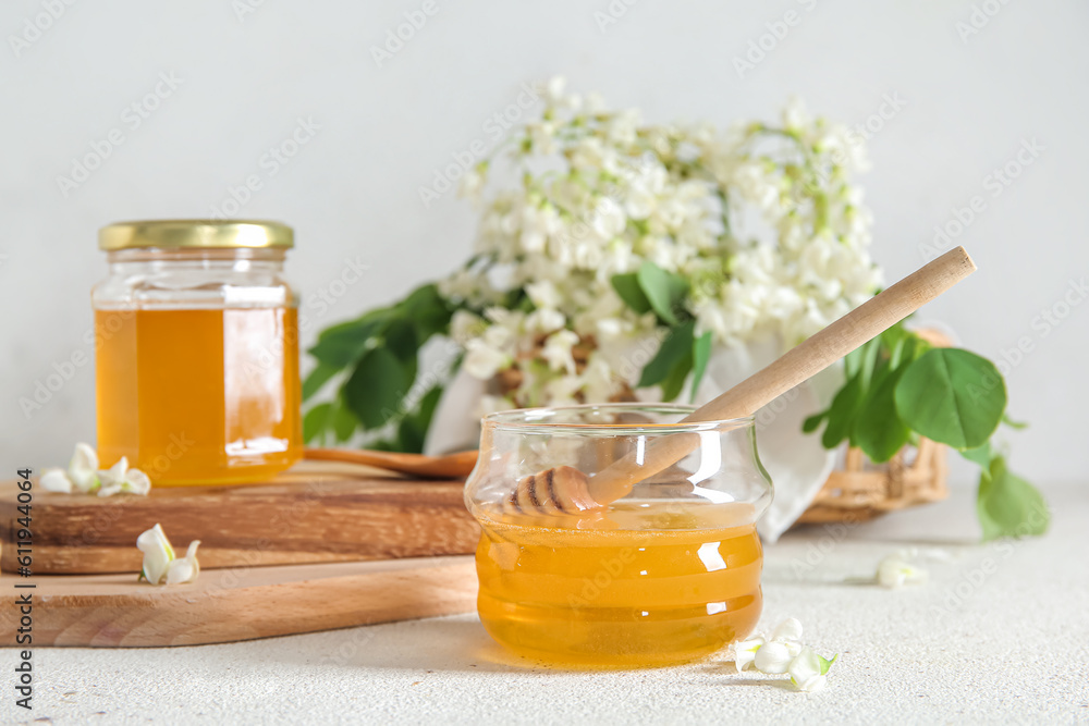Composition with sweet honey and acacia flowers on light background, closeup Composition with sweet honey and acacia flowers on light background, closeup