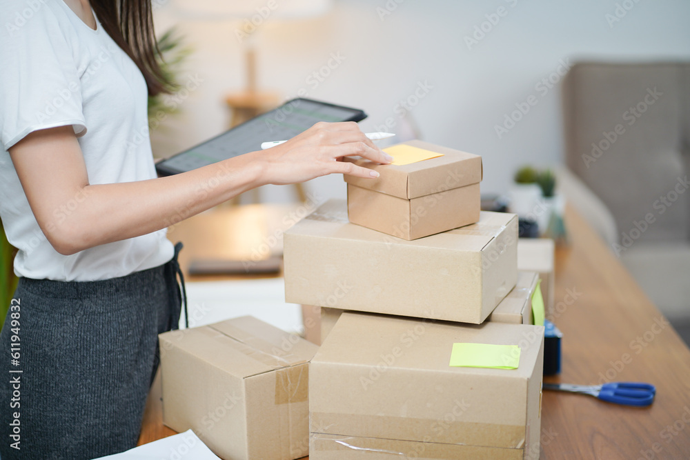 Business From Home Asian woman preparing package delivery box Shipping for shopping online. young start up small business owner at home online order Business From Home Asian woman preparing package delivery box Shipping for shopping online. young start up small business owner at home online order