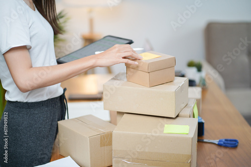 Business From Home Asian woman preparing package delivery box Shipping for shopping online. young start up small business owner at home online order © Charlie's