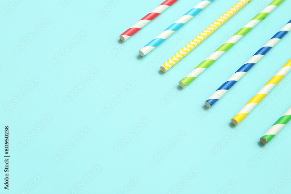 Different paper drinking straws on blue background Different paper drinking straws on blue background