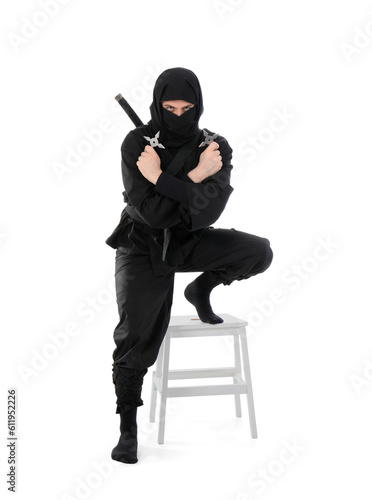 Male ninja with shurikens on white background © Pixel-Shot