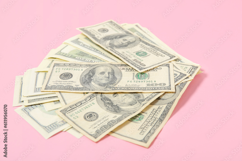 One hundred dollar banknotes on pink background One hundred dollar banknotes on pink background