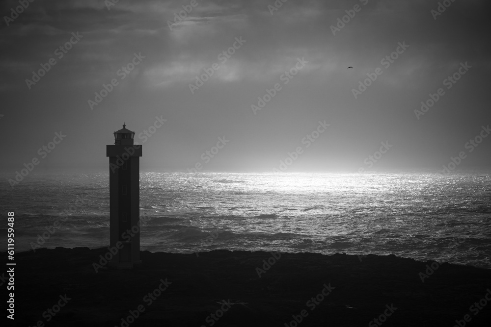 lighthouse at dusk in black and white