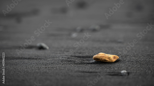 yellow rock on the black beach