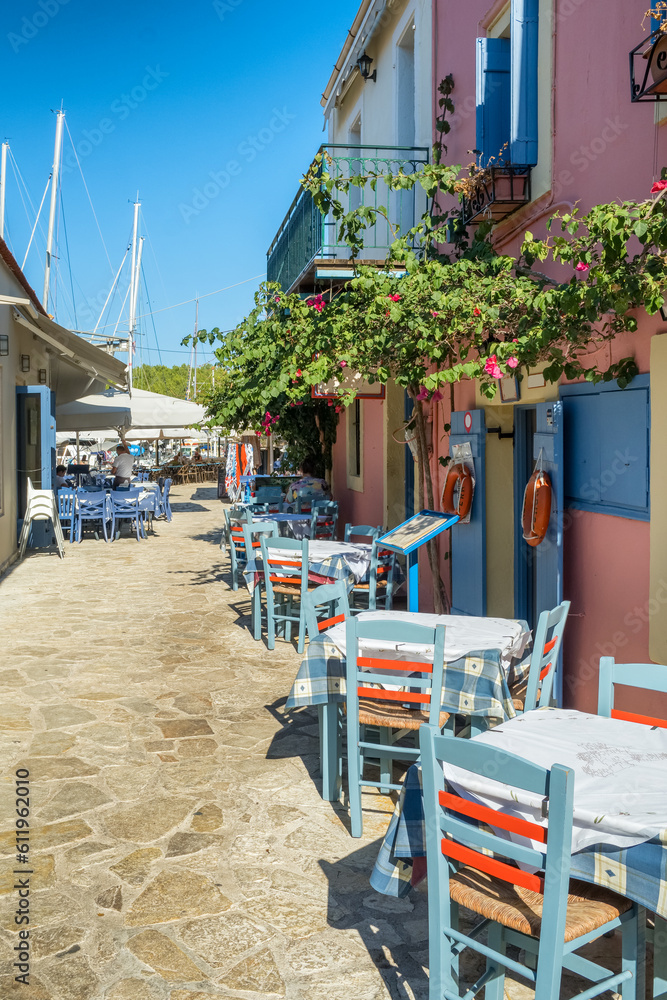 Cozy outdoor cafe in Fiskardo fishing village on Kefalonia island, Greece