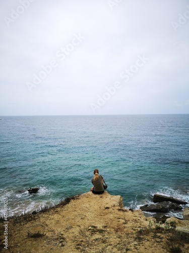 pensive girl in front of the sea