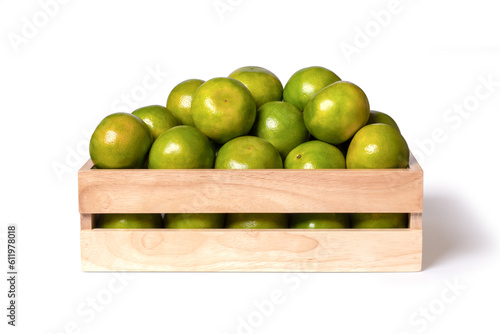 Green tangerine orange fruit in wooden box isolated on white background with clipping path.