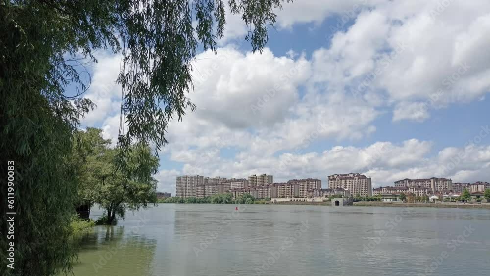 timelapse: large multi-storey buildings in the suburbs of Krasnodar on the banks of the Kuban River under snow-white cumulus clouds on a sunny summer day timelapse: large multi-storey buildings in the suburbs of Krasnodar on the banks of the Kuban River under snow-white cumulus clouds on a sunny summer day