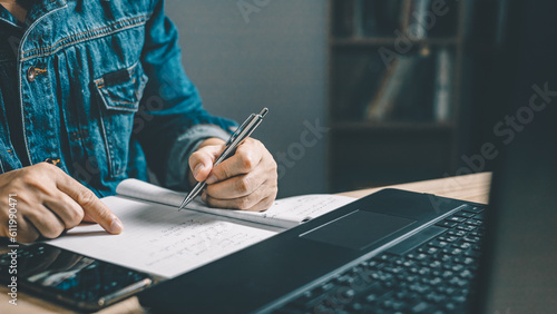 Photography Man using smartphone and taking notes in planning