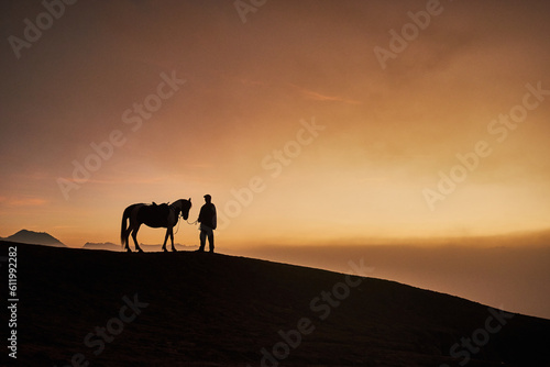 Silhouette of horse and rider on sunset