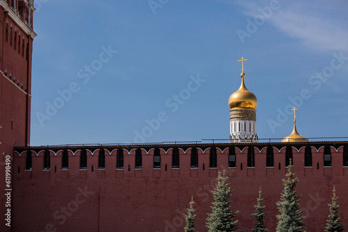 Moscow, Russia, June 2023: View of the bell of Ivan the Great in the Moscow Kremlin behind the Kremlin wall on a sunny summer day. photo