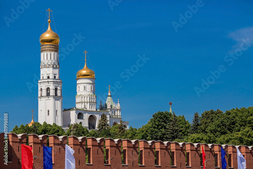 Moscow, Russia, June 2023: View of the bell of Ivan the Great in the Moscow Kremlin behind the Kremlin wall on a sunny summer day.
