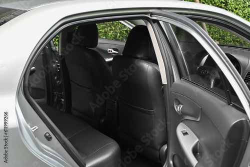 The rear passenger seat is wide and clean. Leather interior, side view, solar sunroof, buttons, Nappa leather, beige,black.