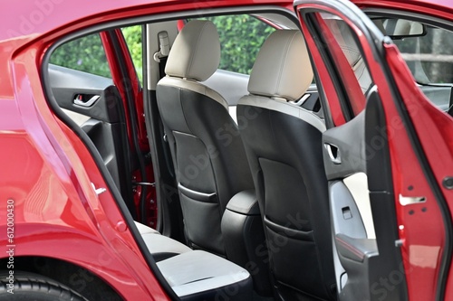 inside the back seat The passenger seat is wide and clean. Leather interior design, car passenger and driver seats, clean, angle view side, sunroof solar, buttons, dashboard, nappa leather, beige.