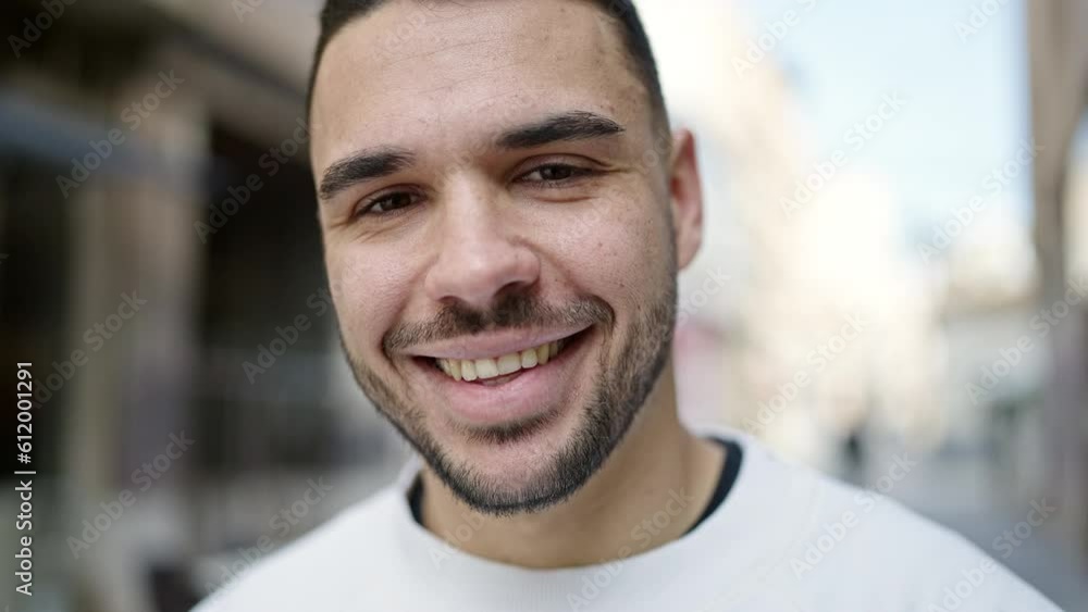 Young hispanic man smiling confident standing at street Young hispanic man smiling confident standing at street