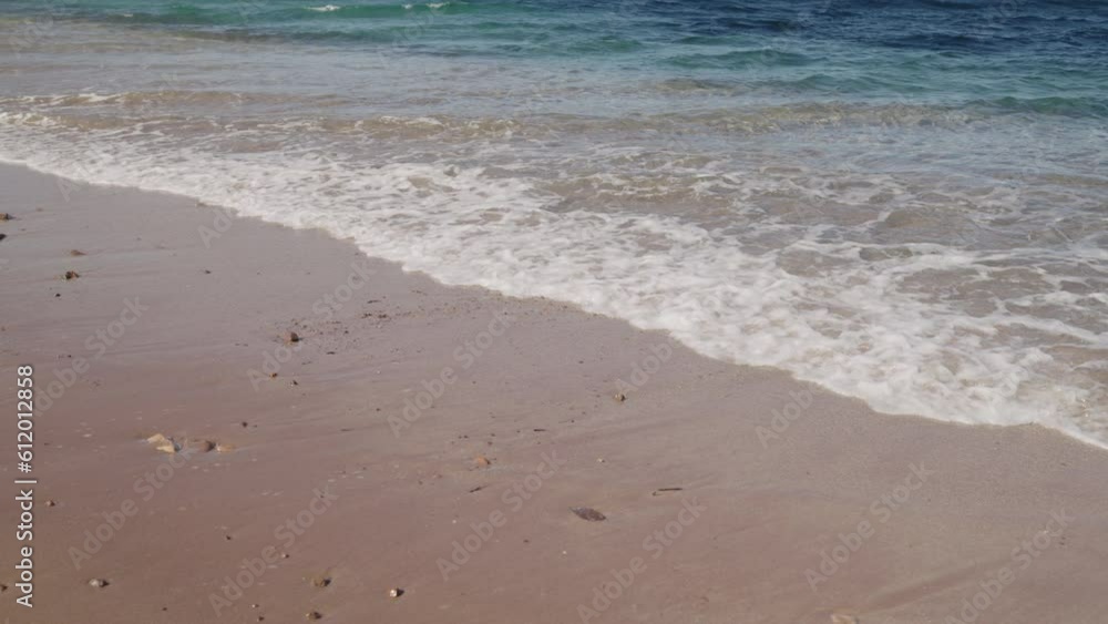 Slow motion of clear sea water on a beach closeup Slow motion of clear sea water on a beach closeup