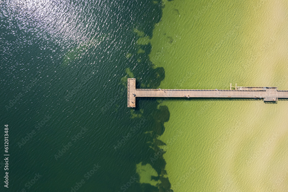 Aerial view of a long pier, levee, jetty. Beautiful sea, beach view from drone. Resort and recreational area. Aerial view of a long pier, levee, jetty. Beautiful sea, beach view from drone. Resort and recreational area.