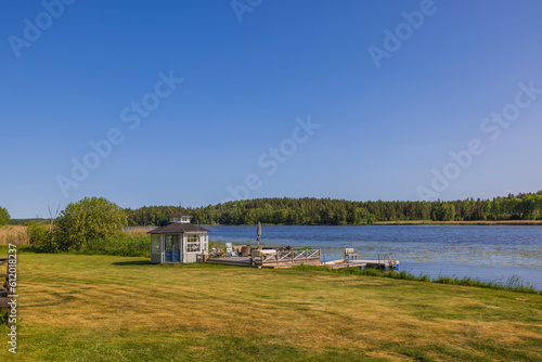 Beautiful view of utility building on lake shore on sunny day. Sweden. Europe. 