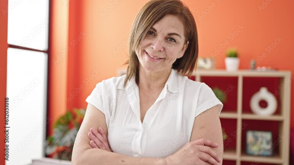 Middle age hispanic woman smiling confident with crossed arms at home Middle age hispanic woman smiling confident with crossed arms at home