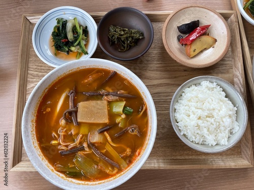spicy korean soup with rice and side dishes 