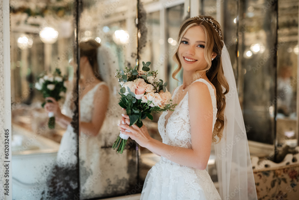 portrait of a bride in a white dress in a bright cafe