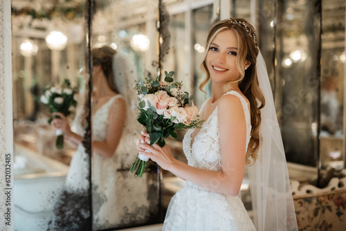 portrait of a bride in a white dress in a bright cafe