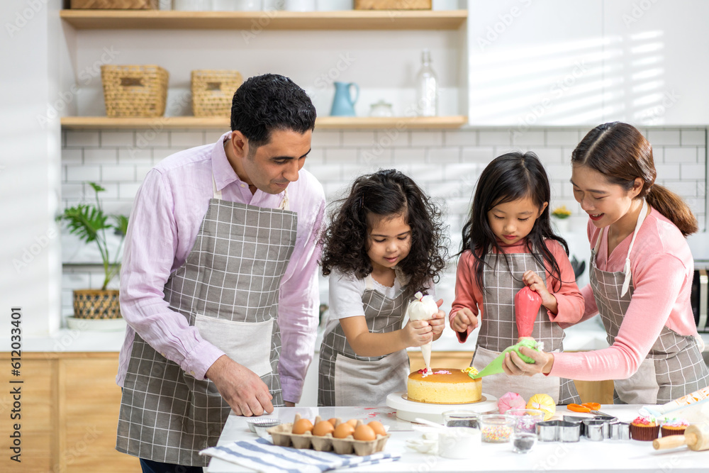 Portrait of enjoy happy love asian family father and mother with little asian girl daughter child play and having fun cooking food together with baking cookie and cake ingredient in kitchen