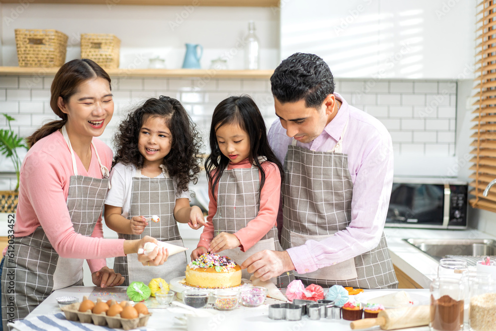 Portrait of enjoy happy love asian family father and mother with little asian girl daughter child play and having fun cooking food together with baking cookie and cake ingredient in kitchen Portrait of enjoy happy love asian family father and mother with little asian girl daughter child play and having fun cooking food together with baking cookie and cake ingredient in kitchen