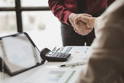 Business investor group holding hands, Two businessmen are agreeing on business together and shaking hands after a successful negotiation. Handshaking is a Western greeting or congratulation.