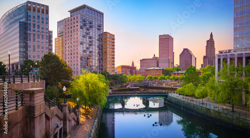 Fototapeta Naklejka Na Ścianę i Meble -  Providence Rhode Island downtown skyline, buildings, tranquil sunrise cityscape, and water reflections on the river 