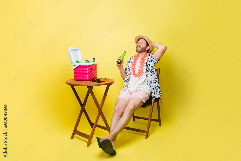Attractive mid adult man relaxing with a beer on his summer vacations Attractive mid adult man relaxing with a beer on his summer vacations