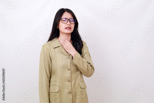 Young pretty Asian woman in civil servant costume having problem on her throat © SetianingDyah