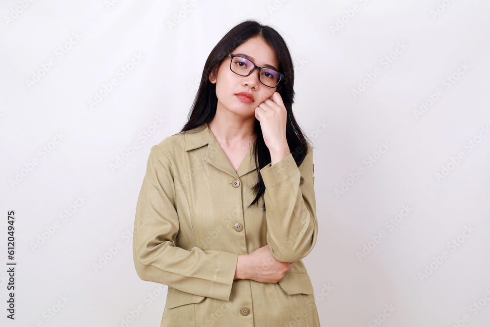 Sad young indonesian government worker standing while doing nothing Sad young indonesian government worker standing while doing nothing
