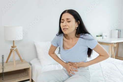 woman hand touching abdomen having stomach ache, female eating food poisoning causes flatulence, digestive disease, Abdominal pain during menstruation. Health problem concept