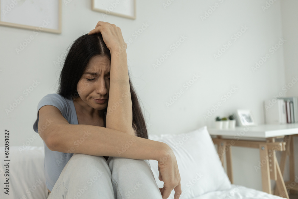 Female having depression sitting alone in bedroom corner. woman headache unhappy emotion. young anxiety despairing mental health problems. Female having depression sitting alone in bedroom corner. woman headache unhappy emotion. young anxiety despairing mental health problems.