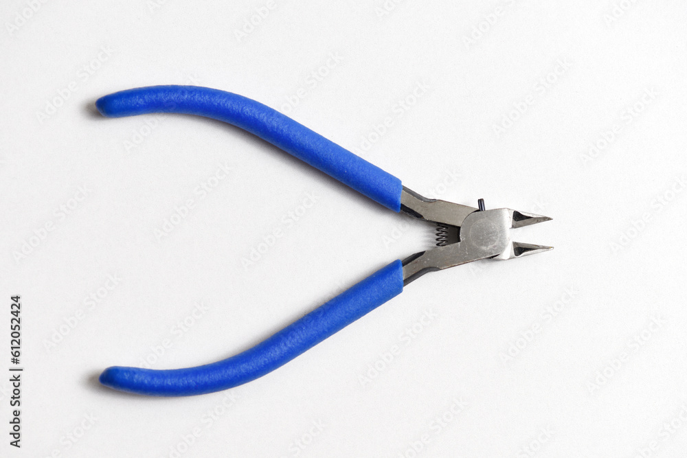 close up pliers lay on white background ready for plastic model kit work close up pliers lay on white background ready for plastic model kit work