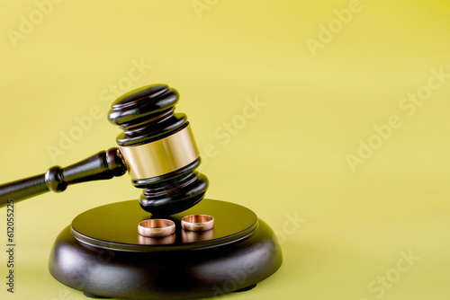 Judge gavel and two golden marriage ring, Contract decree of divorce dissolution or cancellation of marriage photo