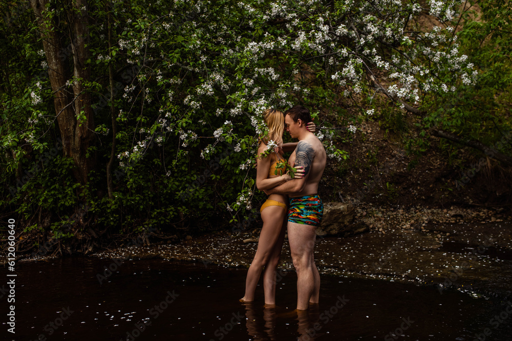 Beautiful couple in water hugging and kissing at night Beautiful couple in water hugging and kissing at night