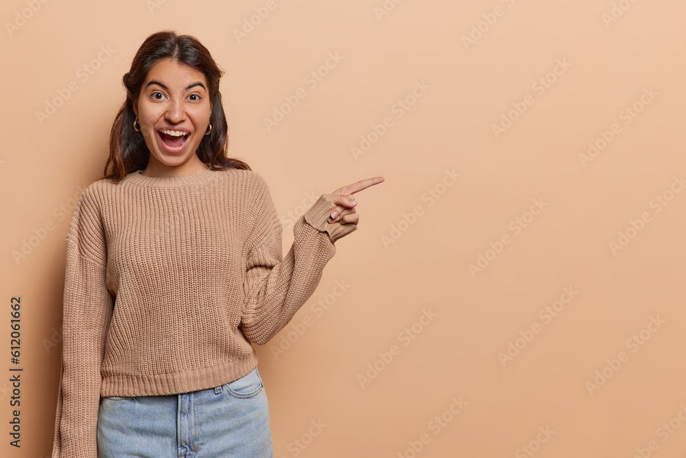 Pretty woman enthusiastically shows something incredible her gestures animated captivating leaving viewers intrigued eager to discover extraordinary sight she is sharing wears knitted jumper and jeans Pretty woman enthusiastically shows something incredible her gestures animated captivating leaving viewers intrigued eager to discover extraordinary sight she is sharing wears knitted jumper and jeans