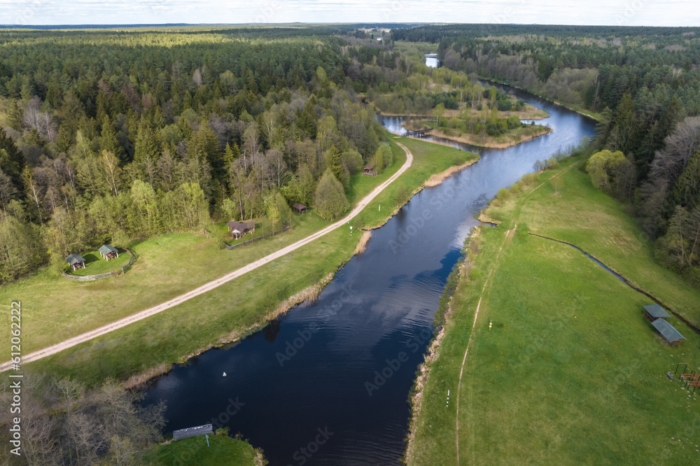 panoramic view from a high altitude of a meandering river in the forest near village