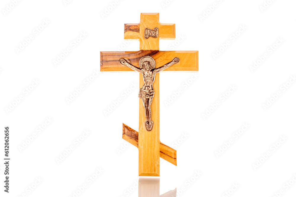 One wooden church cross, macro, isolated on white background.