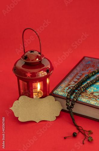 Ramadan Kareem Greeting Image with blank label, Red colour lantern lamp and Quran with Tasbih
